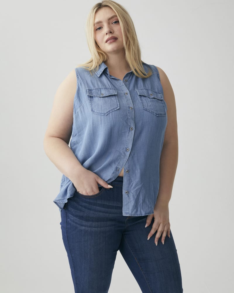 Front of a model wearing a size 1X Diana Sleeveless Button-Up Top in Medium Wash by Molly & Isadora. | dia_product_style_image_id:266511